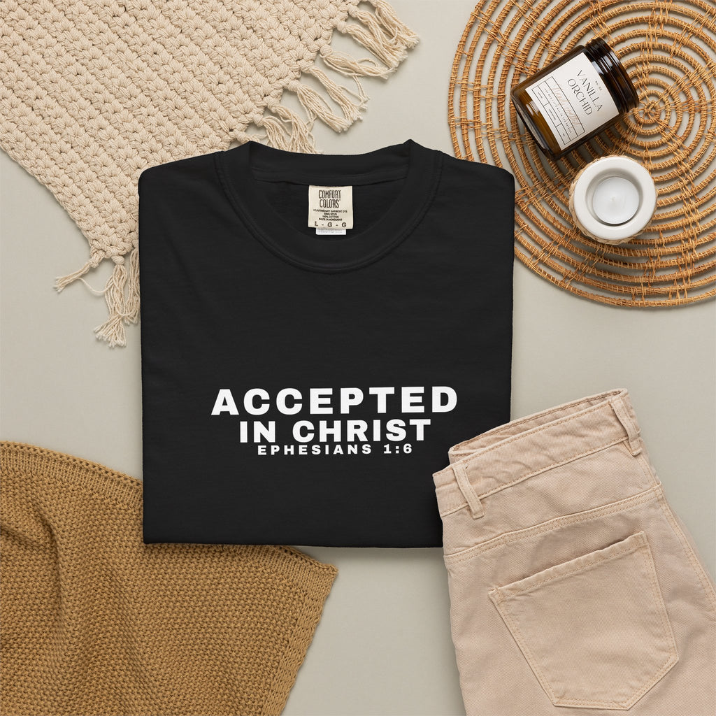 Black t-shirt with 'Accepted in Christ' text on a neutral background