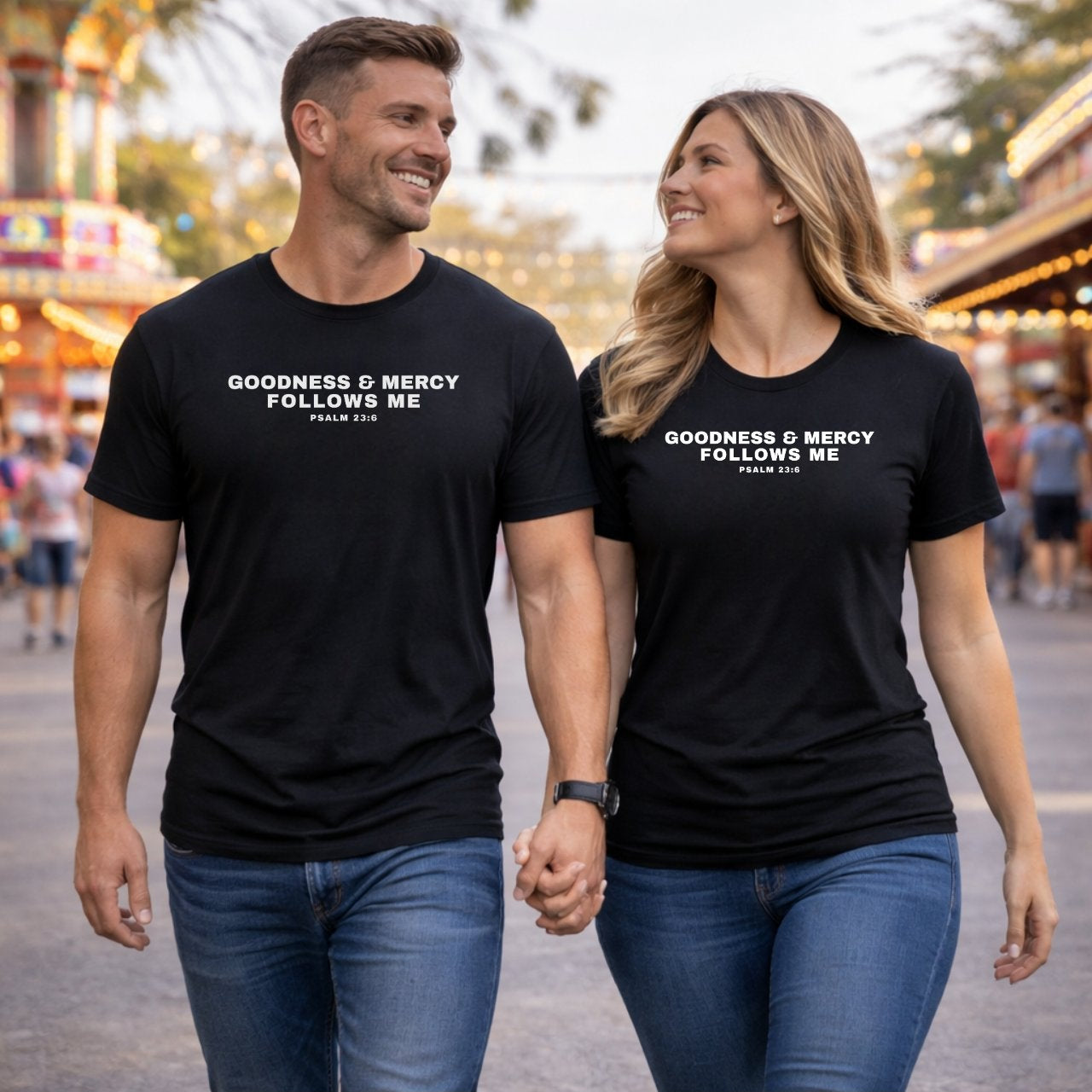 Two people wearing black t-shirts with text, walking together in an outdoor setting.